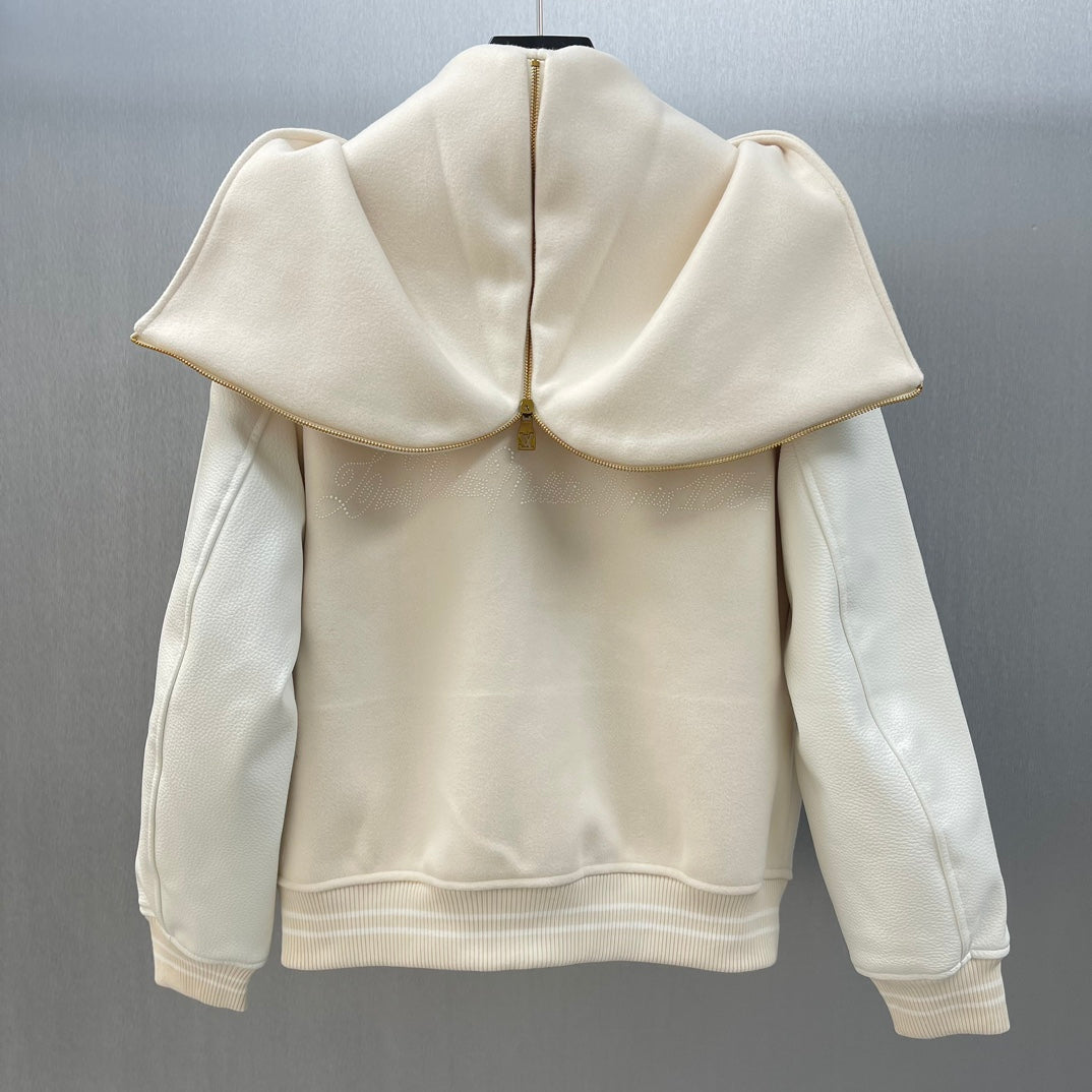 Cream hooded jacket back view with cape-like shoulders and ribbed hem