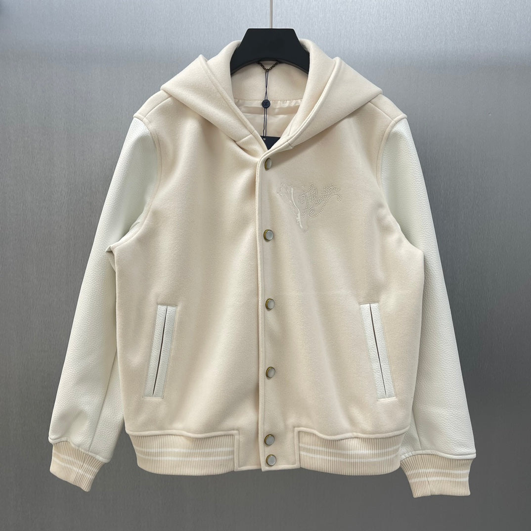 Cream hooded jacket with button front, side pockets, and embroidered Louis Vuitton crest