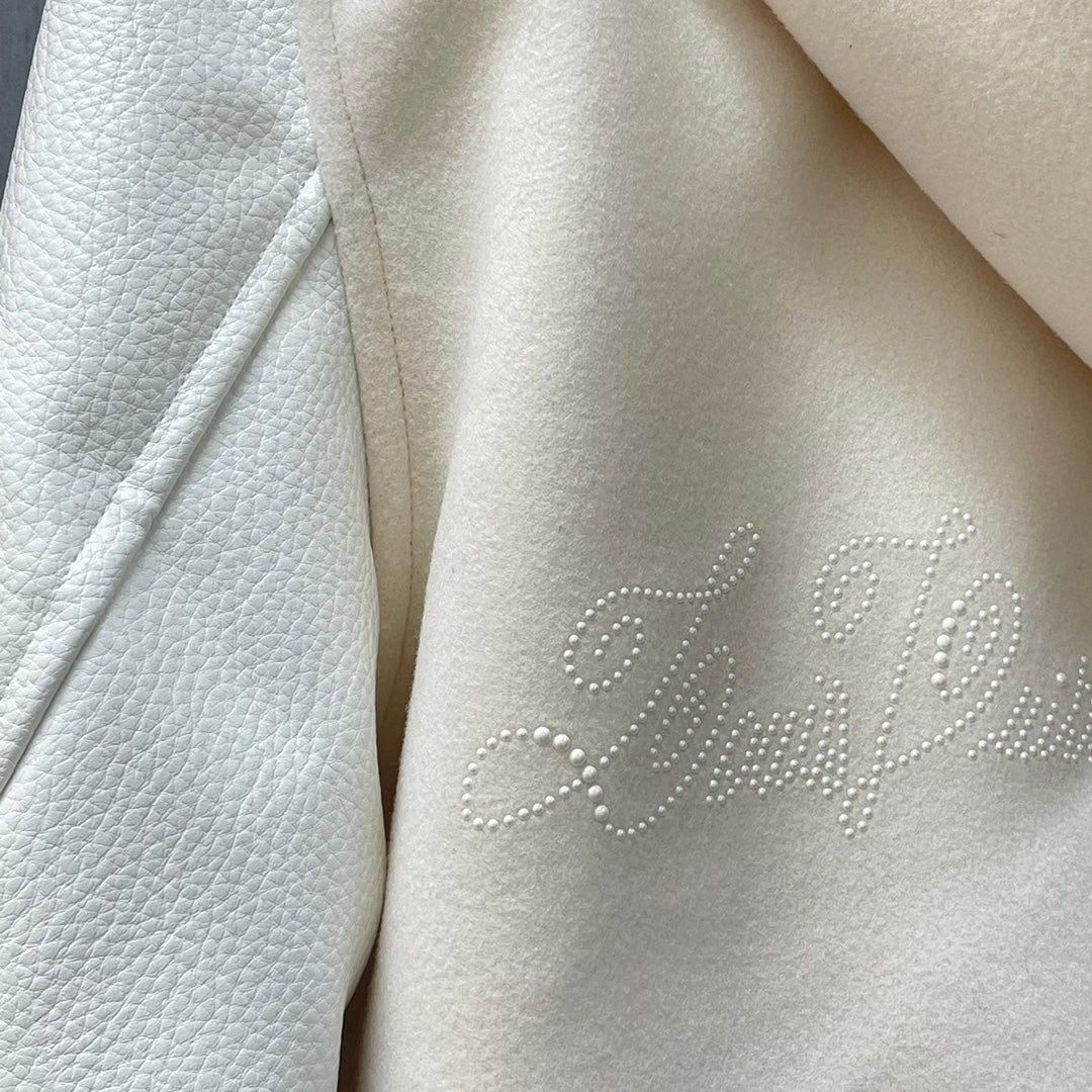 Cream jacket shoulder and sleeve with rhinestone Louis Vuitton logo detail
