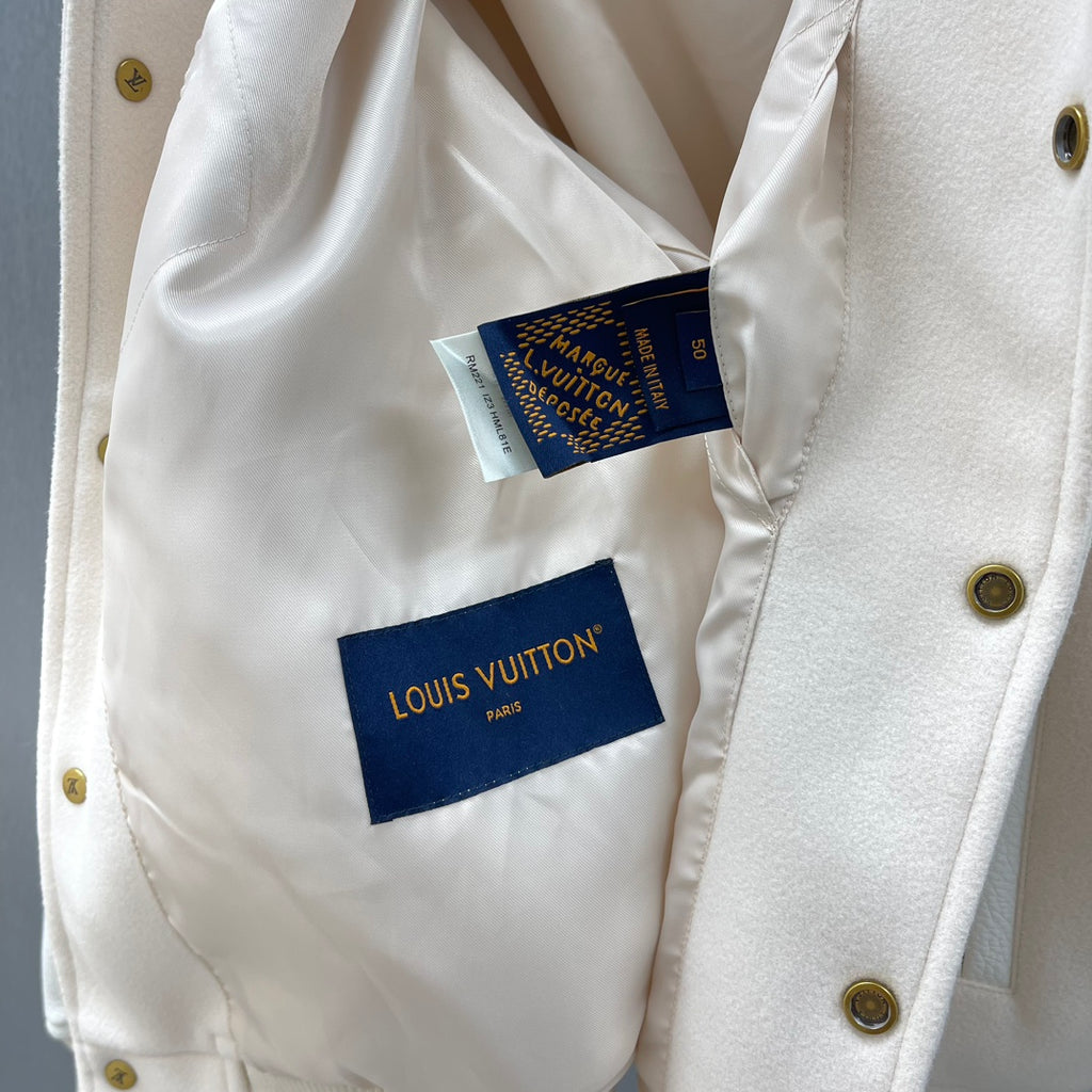 Cream jacket inside label area with Louis Vuitton tags and button placket