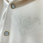 Cream jacket chest detail with rhinestone Louis Vuitton logo and gold-tone button