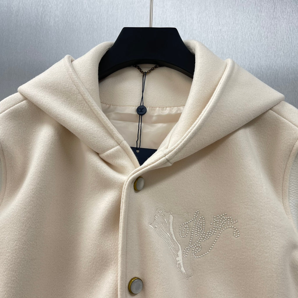 Cream hooded jacket neckline detail with metal button and embossed Louis Vuitton script