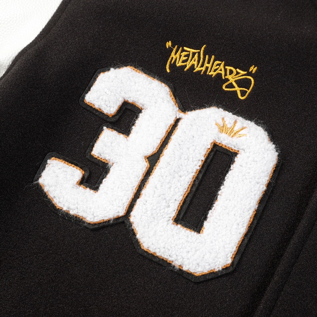 Black varsity jacket with large 30 applique and Metalhead patch detail