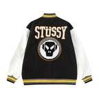Black and white varsity jacket back with Stüssy logo and crest patch