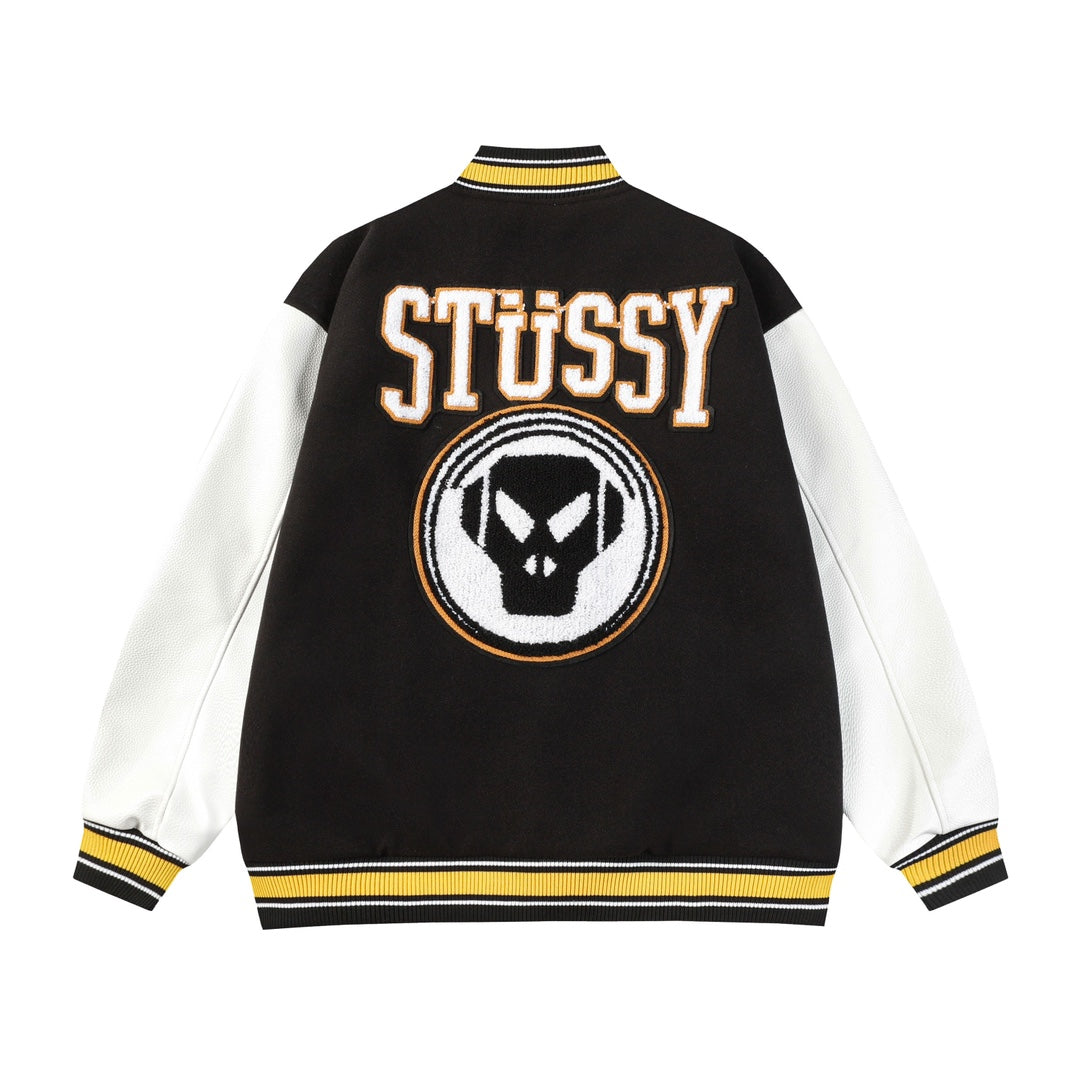 Black and white varsity jacket back with Stüssy logo and crest patch