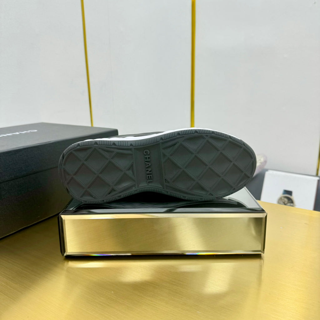 Chanel unisex sneakers with quilted dark green uppers and patterned rubber soles