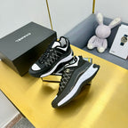 Lace-up sneakers with black patterned upper and white midsole, shown from side angle