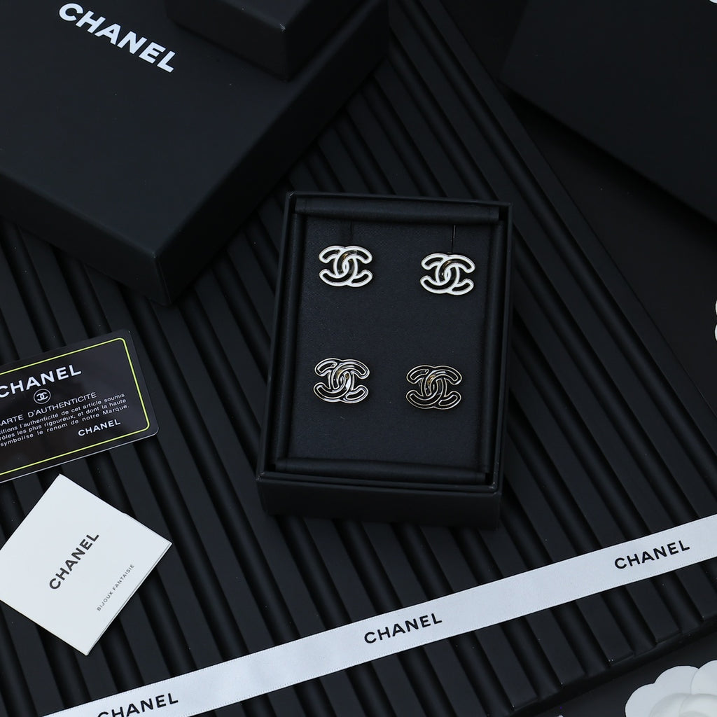 CC logo stud earrings set in a black presentation box with white branding strips