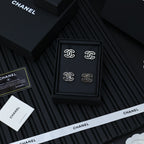 CC logo stud earrings set in a black presentation box with white branding strips