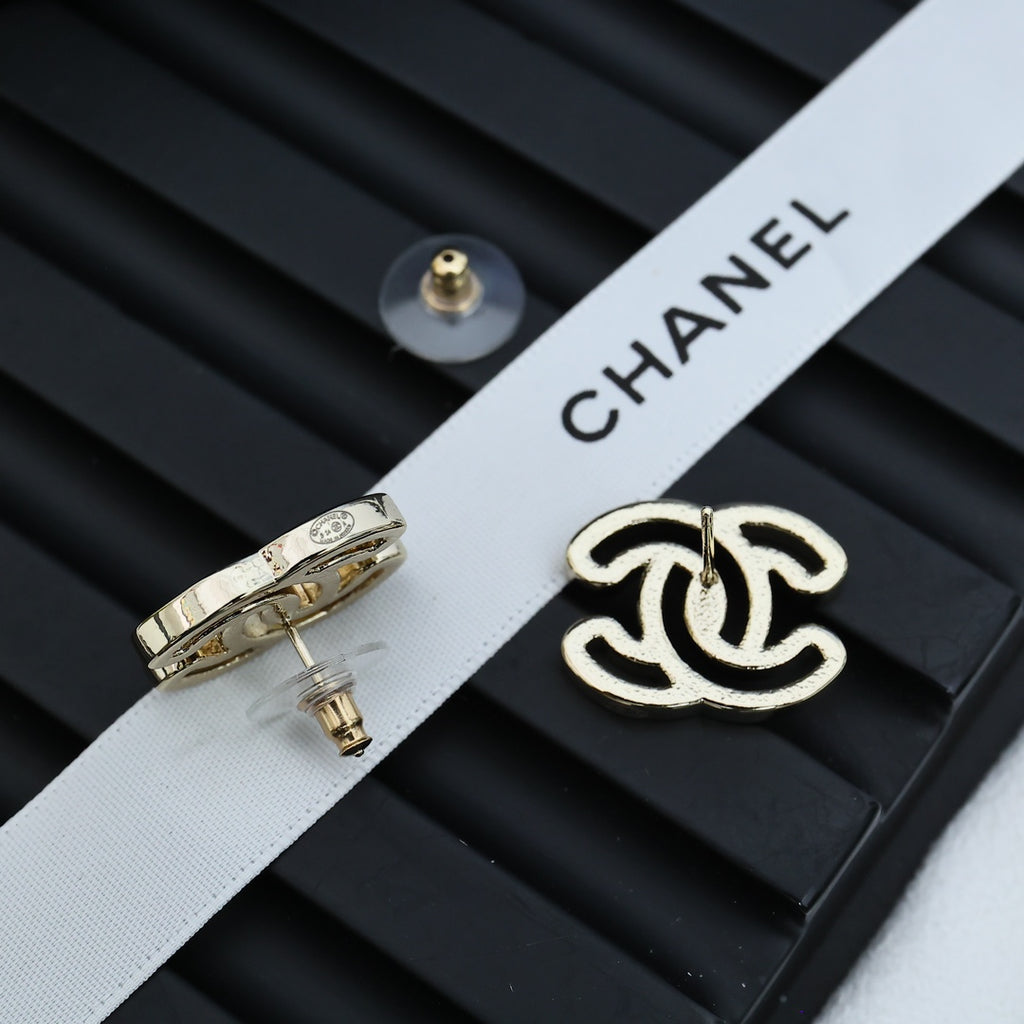 CC logo stud earrings with silver-toned metal and black enamel, side view