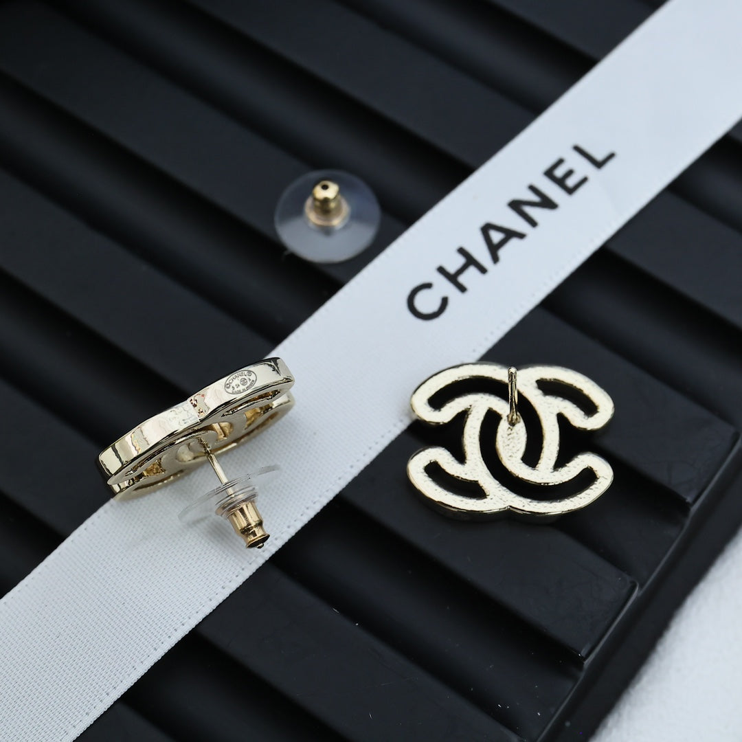 CC logo stud earrings with silver-toned metal and black enamel, side view