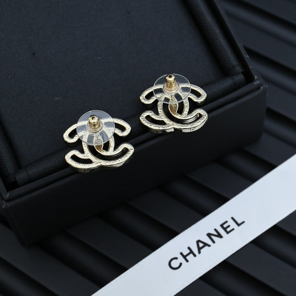 CC logo stud earrings with gold-toned posts and silver-toned designs