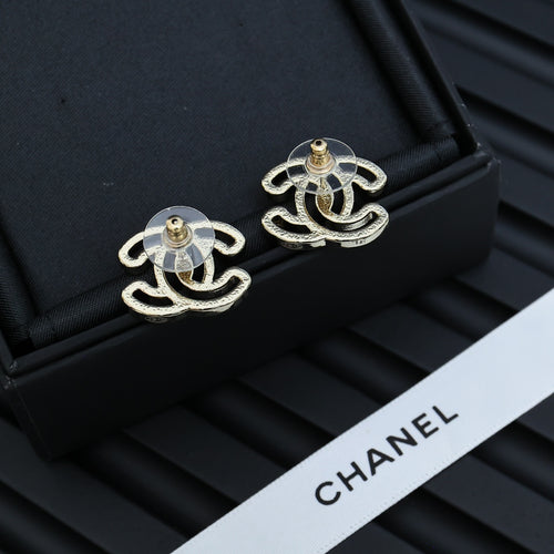 CC logo stud earrings with gold-toned posts and silver-toned designs