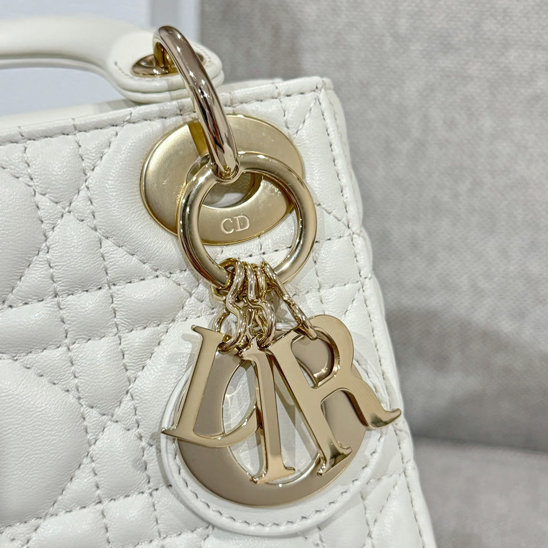 White quilted Dior handbag charm with gold-tone ring and CD monogram plate