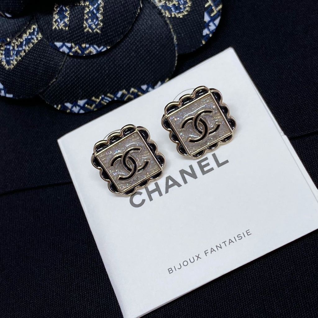Square stud earrings with silver Chanel logo and scalloped metal edging
