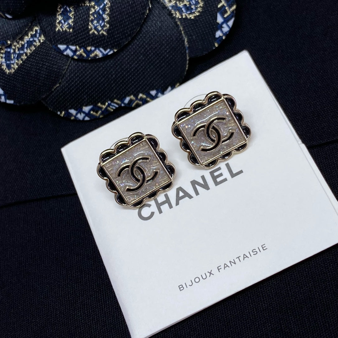 Square stud earrings with silver Chanel logo and scalloped metal edging