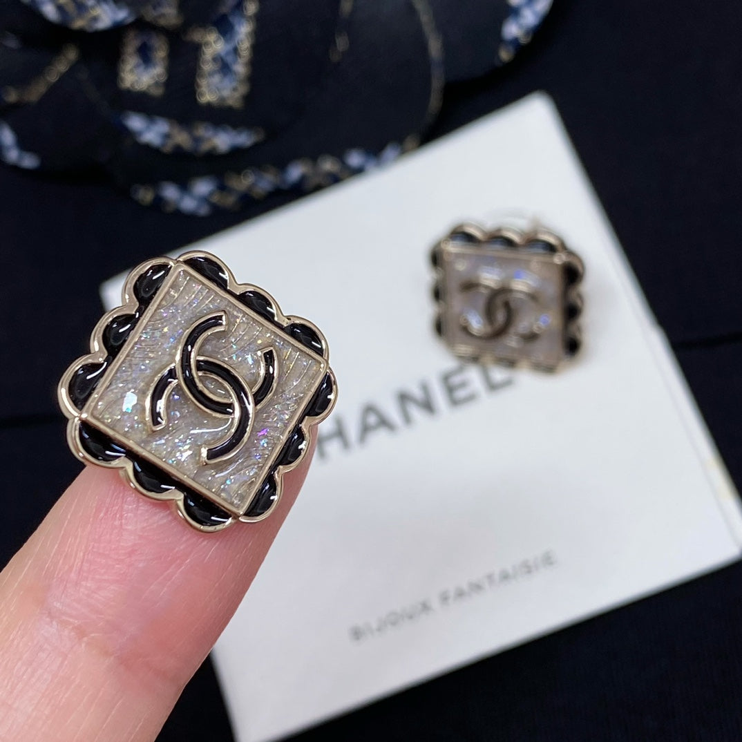 Silver-tone square stud earrings with Chanel logo, scalloped edge design