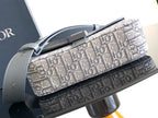 Dior crossbody bag top view with metal strap ring and Dior Oblique canvas exterior.
