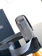 Dior crossbody bag rolled strap detail, showing Dior Oblique canvas lining and hardware.