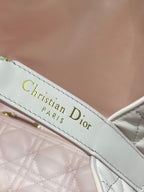 Dior handbag leather strap label reading “Christian Dior PARIS” in gold