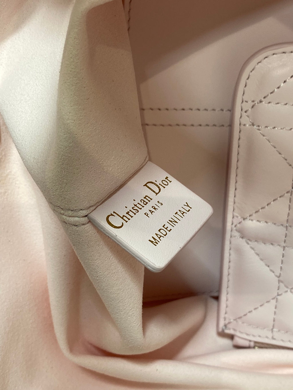 Dior handbag interior label reading “Christian Dior MADEINITALY”