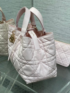 Dior handbag light pink quilted leather tote with top handles and gold accents