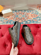 Louis Vuitton monogram slip-on sandals with black trim and sturdy outsole