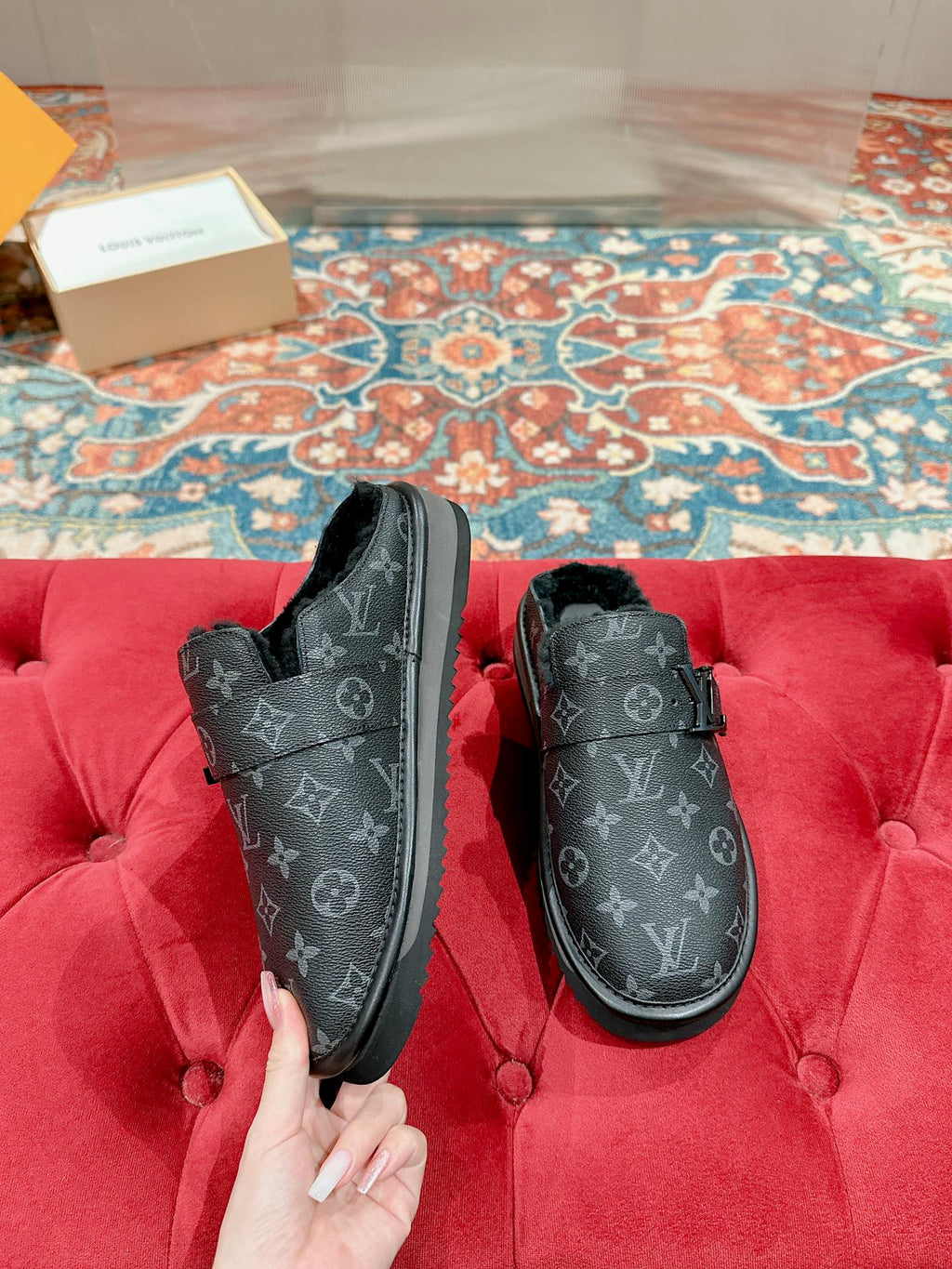 Black Louis Vuitton monogram slide sandals, front view with buckle strap and faux-fur