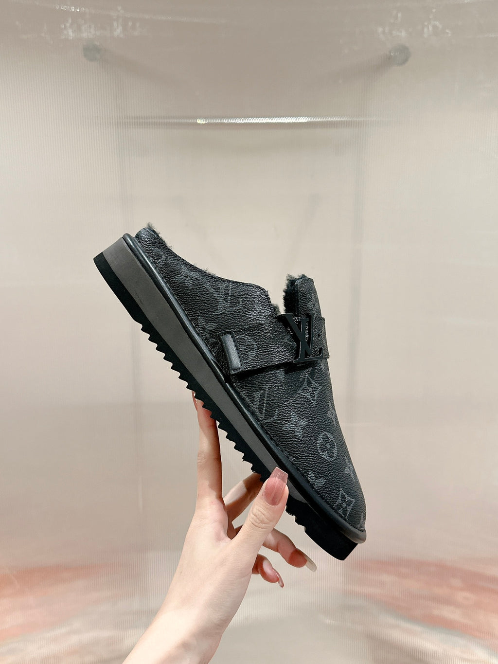 Black Louis Vuitton monogram slide sandal, side view, buckle strap and ridged sole
