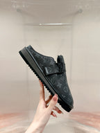 Black Louis Vuitton monogram slide sandal, side view, buckle strap and ridged sole