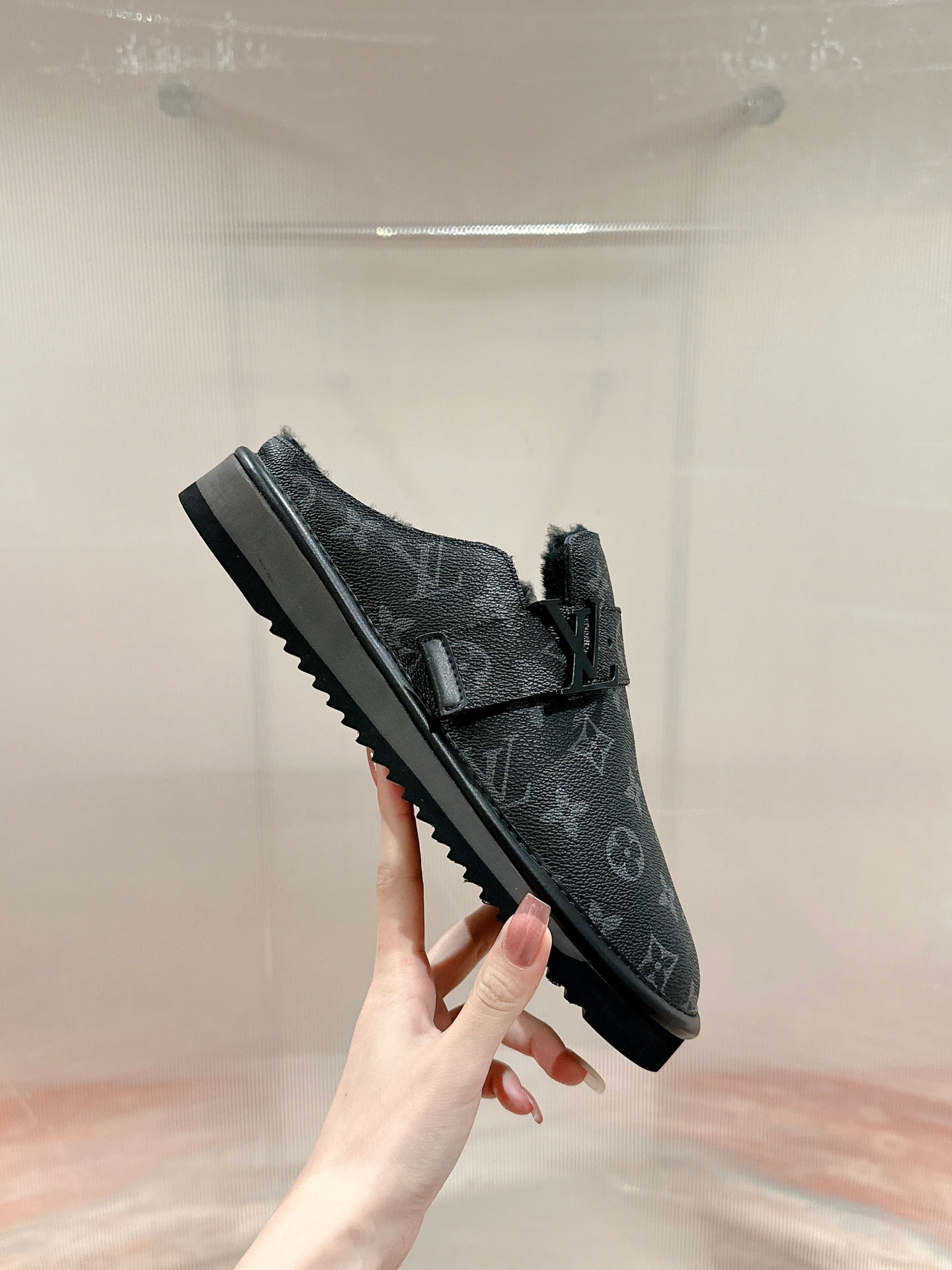 Black Louis Vuitton monogram slide sandal, side view, buckle strap and ridged sole