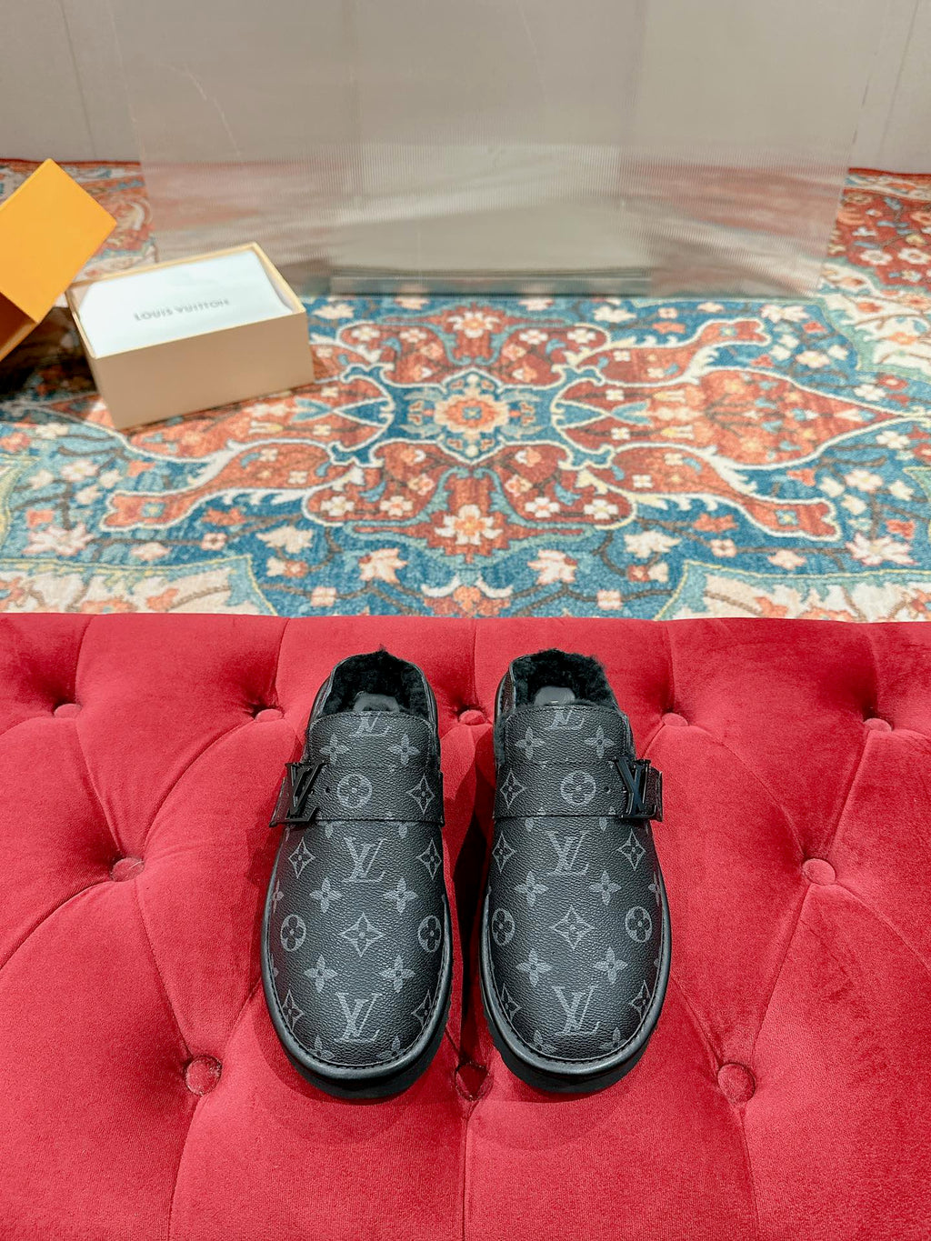 Black Louis Vuitton monogram slide sandals with faux-fur lining and buckle strap