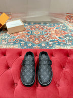 Black Louis Vuitton monogram slide sandals with faux-fur lining and buckle strap