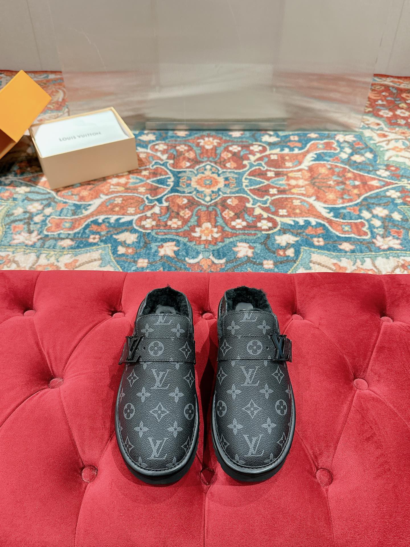 Black Louis Vuitton monogram slide sandals with faux-fur lining and buckle strap