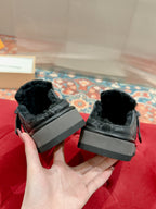 Pair of black Louis Vuitton monogram slide sandals, back view with chunky sole blocks