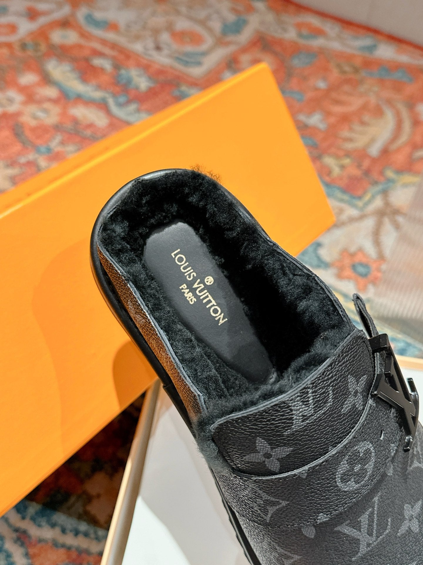 Black Louis Vuitton monogram slide sandal with faux-fur lining and strap detail