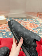 Black Louis Vuitton monogram slide sandal, close side view with buckle strap