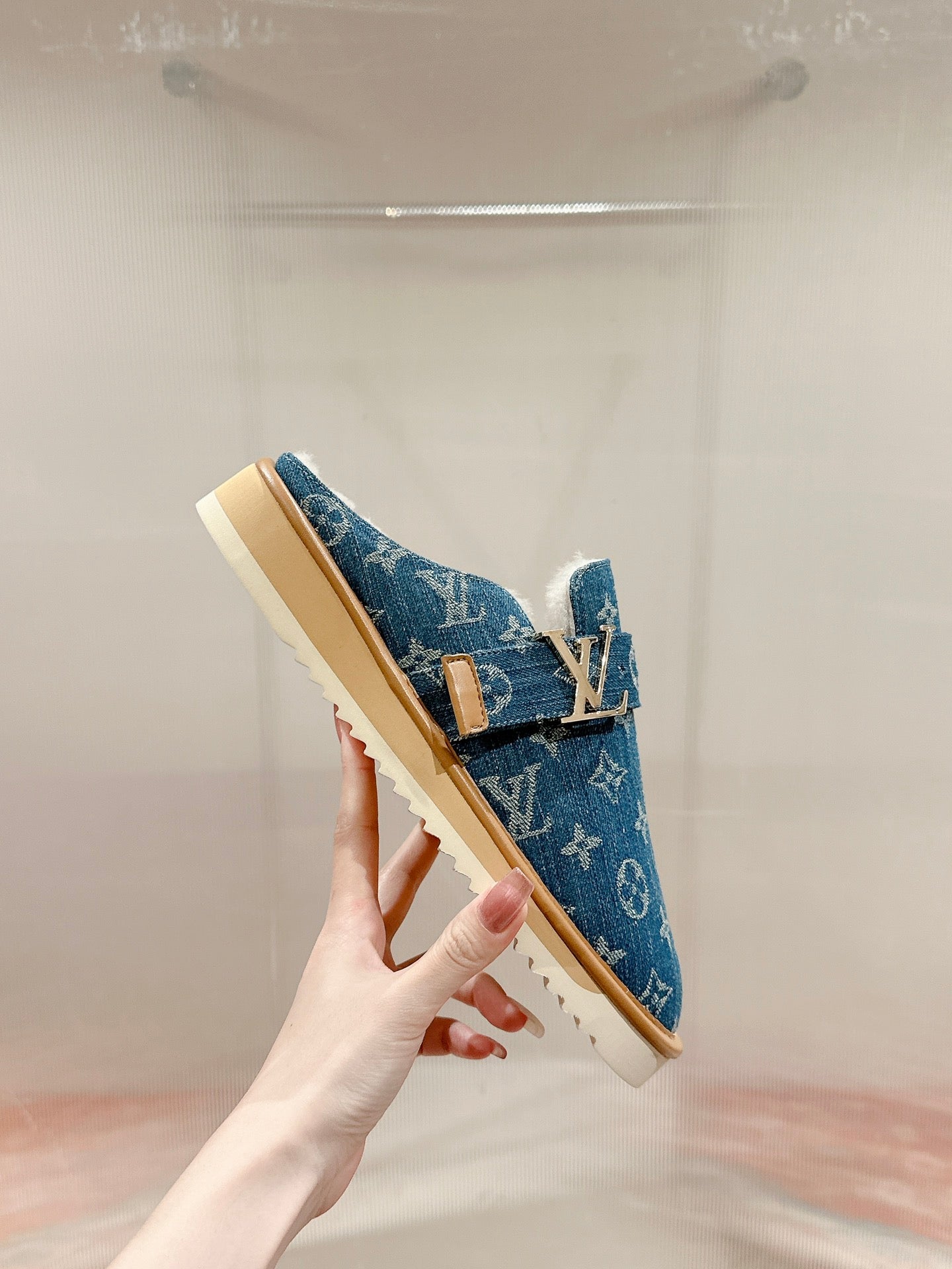 Blue Louis Vuitton monogram slide sandal, side view with tan sole and top strap.