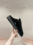 Black Louis Vuitton monogram slide sandal with textured sole edge
