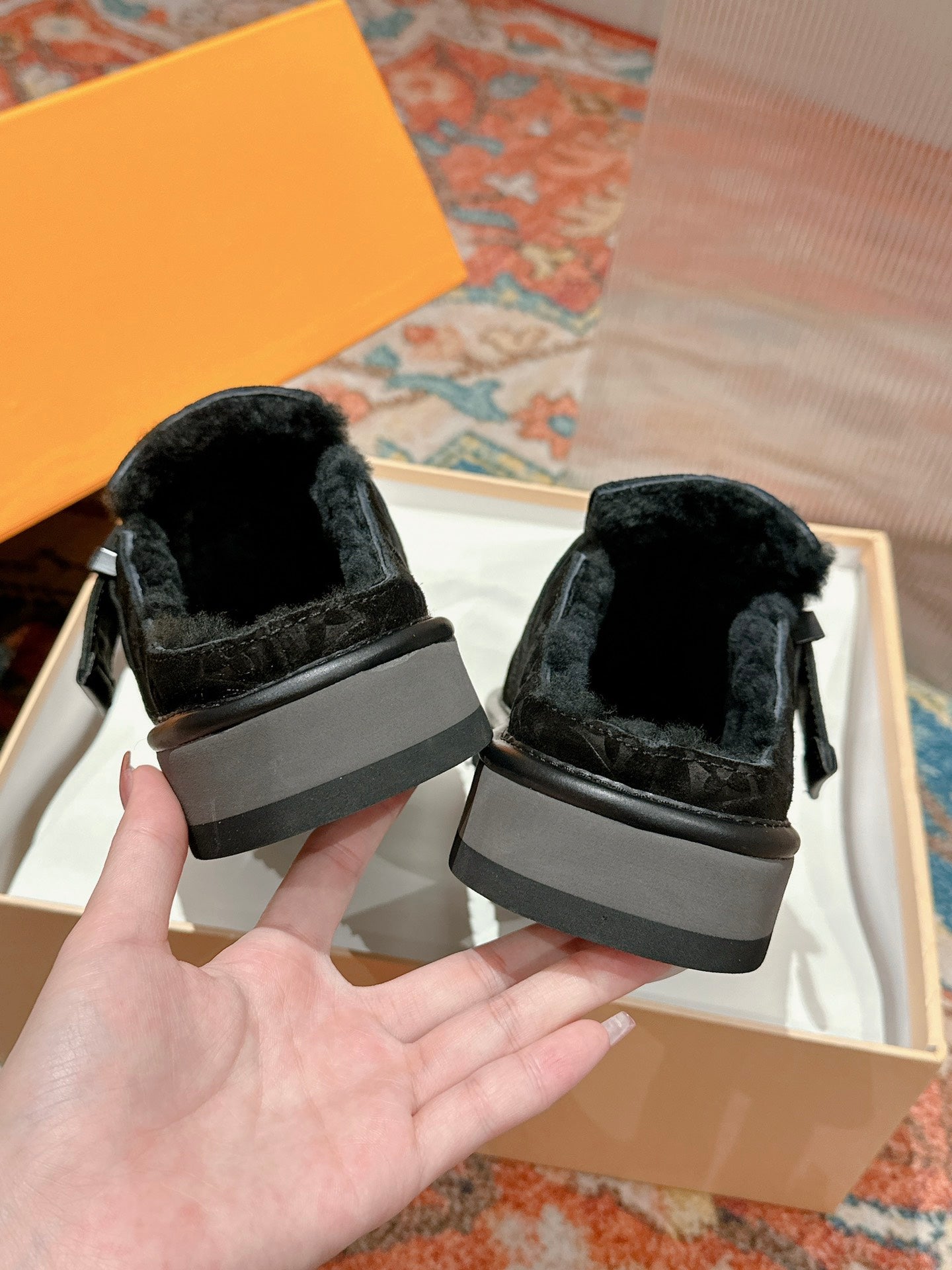 Back view of black Louis Vuitton slide sandals with gray rubber heel band