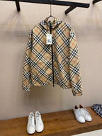Hooded zip jacket with beige and navy plaid pattern and drawstring hem