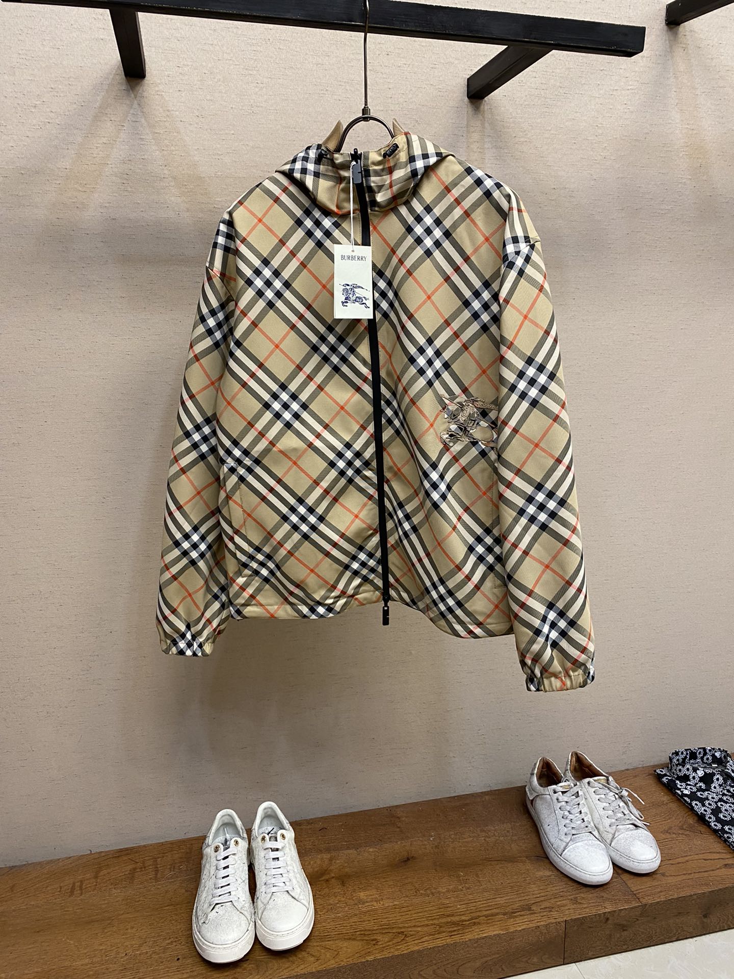 Hooded zip jacket with beige and navy plaid pattern and drawstring hem