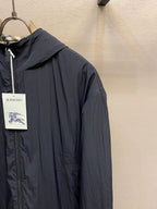 Dark navy hooded zip jacket with smooth fabric and seam details