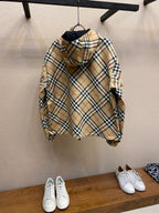 Back of hooded zip jacket with beige, navy, and red plaid