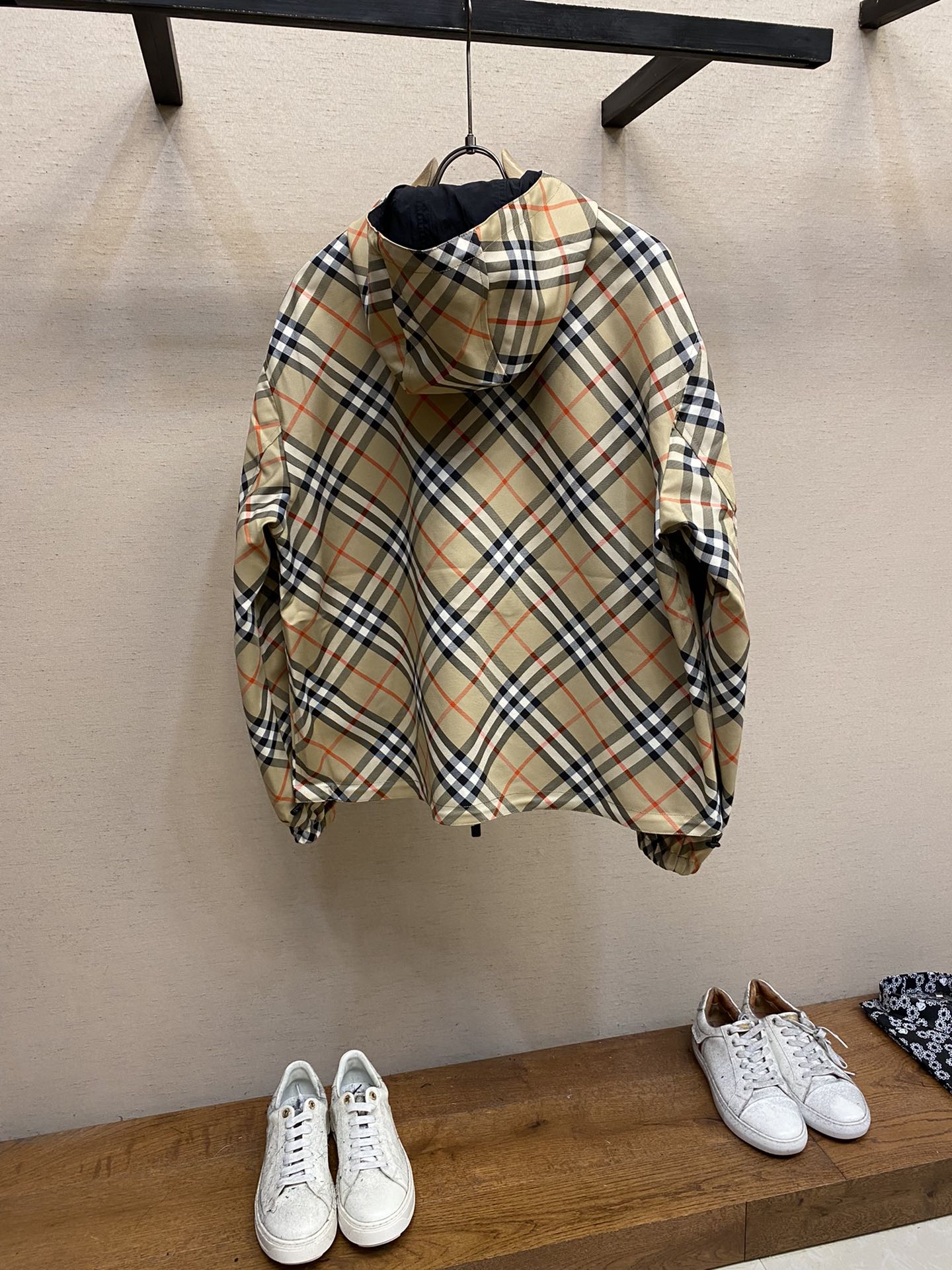Back of hooded zip jacket with beige, navy, and red plaid