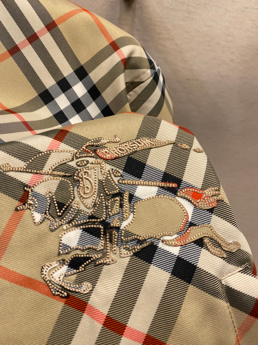 Beige plaid hooded jacket with large embroidered horse graphic on chest