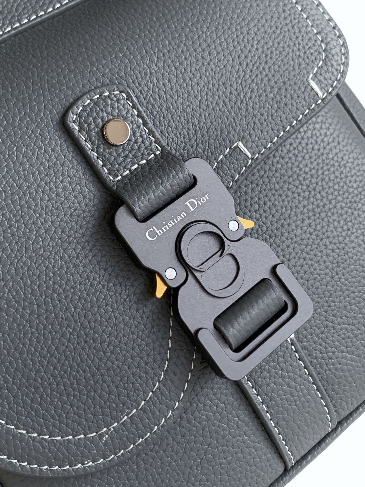 Gray leather flap with Dior logo snap pocket and key charm