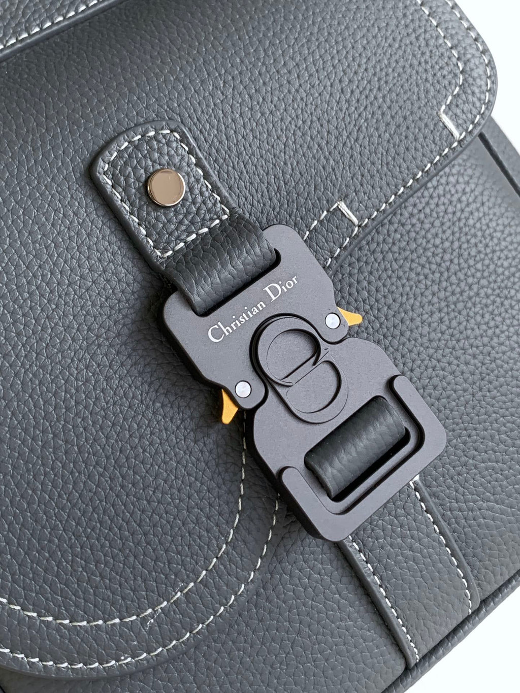 Gray leather bag key charm with DIOR logo tag and metal clip