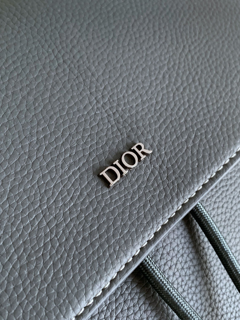 Gray leather panel with embossed DIOR lettering