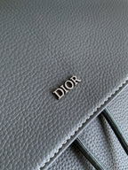 Gray leather bag panel with embossed DIOR logo and stitched trim